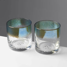Load image into Gallery viewer, Cocktail glasses with blue / teal color stripe against a contrasting gray background.