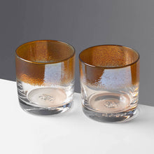 Load image into Gallery viewer, The Aristocrat cocktail glasses with transparent amber / orange color stripe against a contrasting gray background.