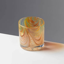Load image into Gallery viewer, Oak Grain style cocktail glass with amber and tan swirls against a contrasting gray background.