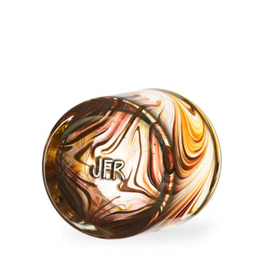 Oak Grain style Rocks Glass with amber and tan swirls, bottom of cup with a stamp of the Artists Initials.